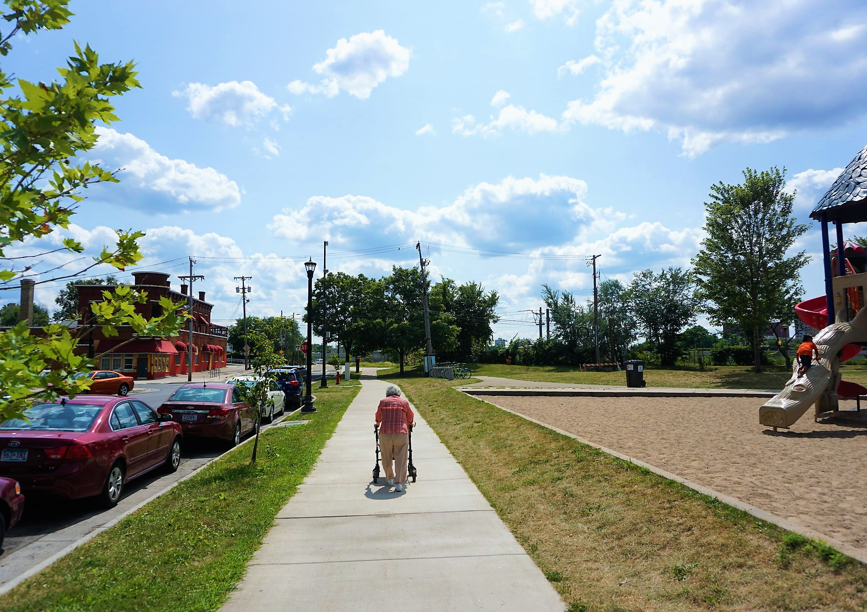 Senior walking down sidewalk