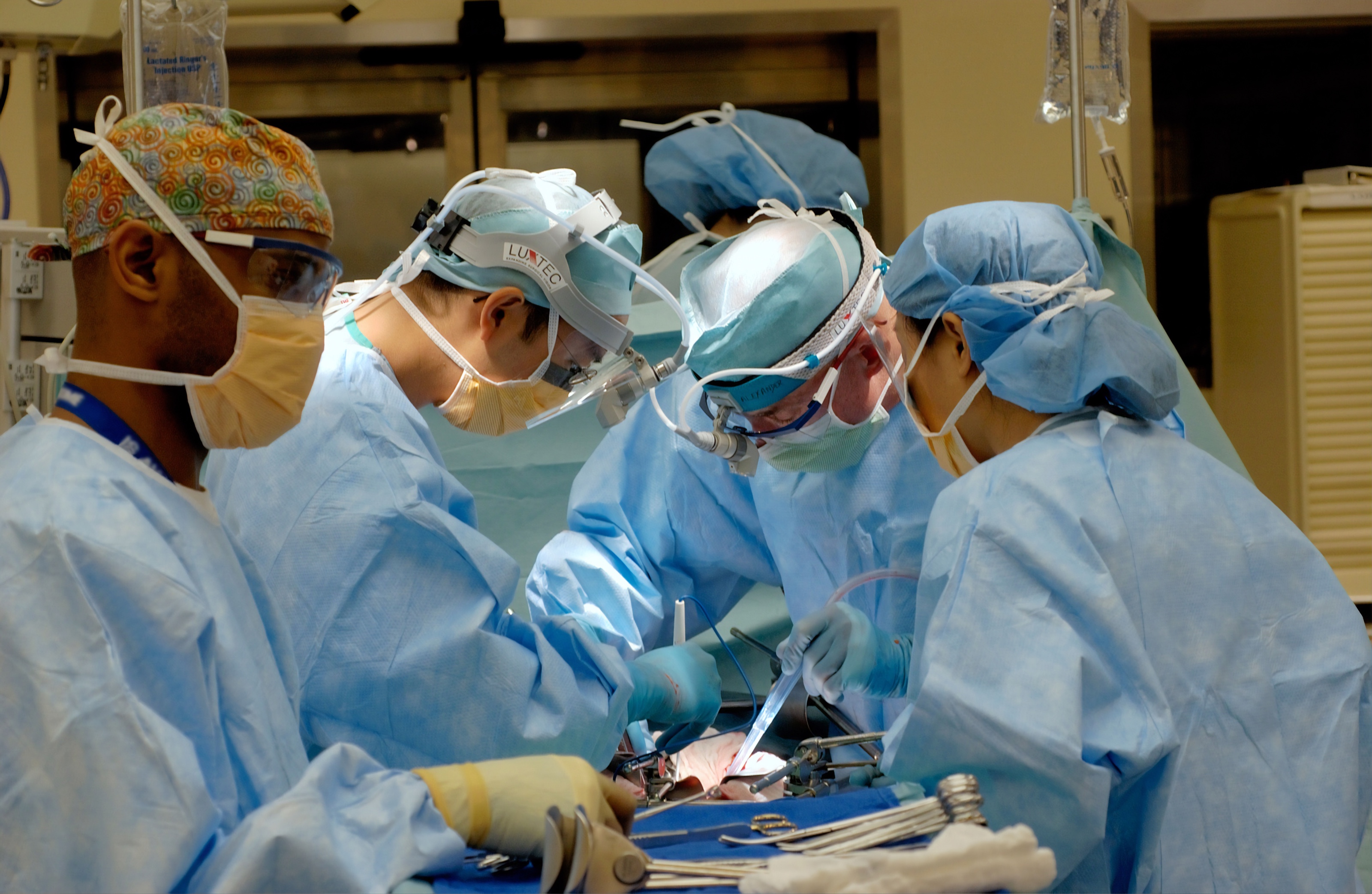 medical worker in blue scrubs working on patient