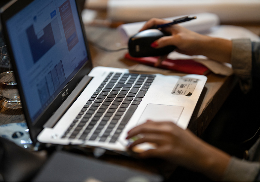 Person's hands on laptop keys looking at data