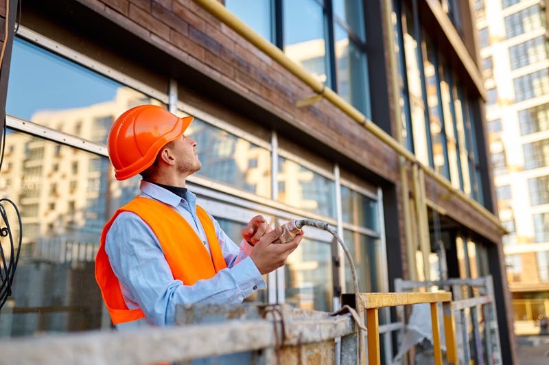 Construction worker wearing a hardhat at a construction site.