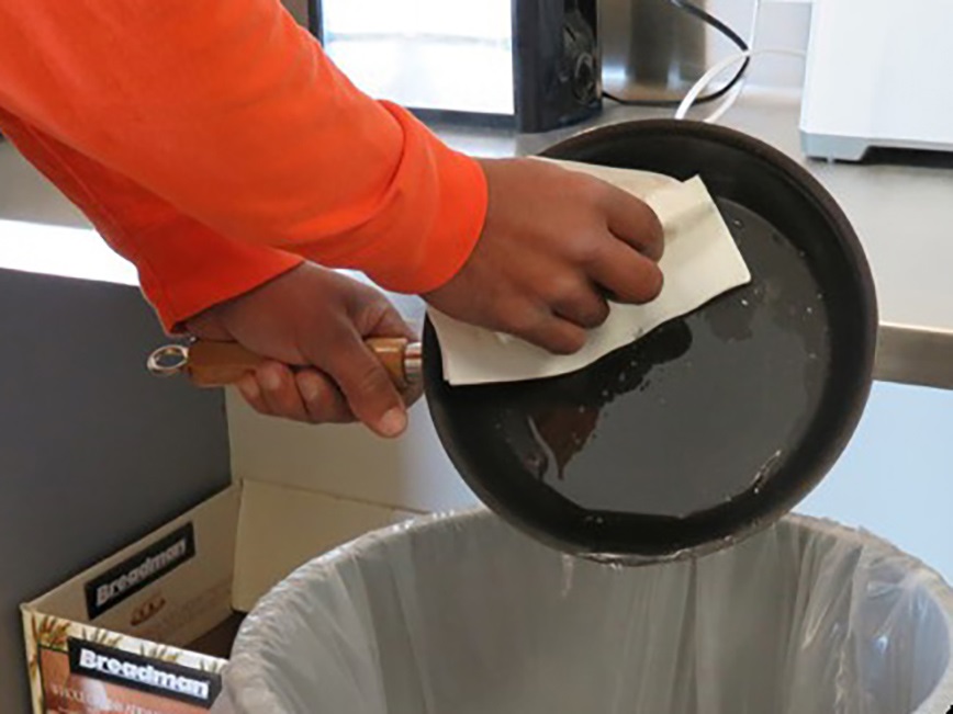 Person cleaning skillet
