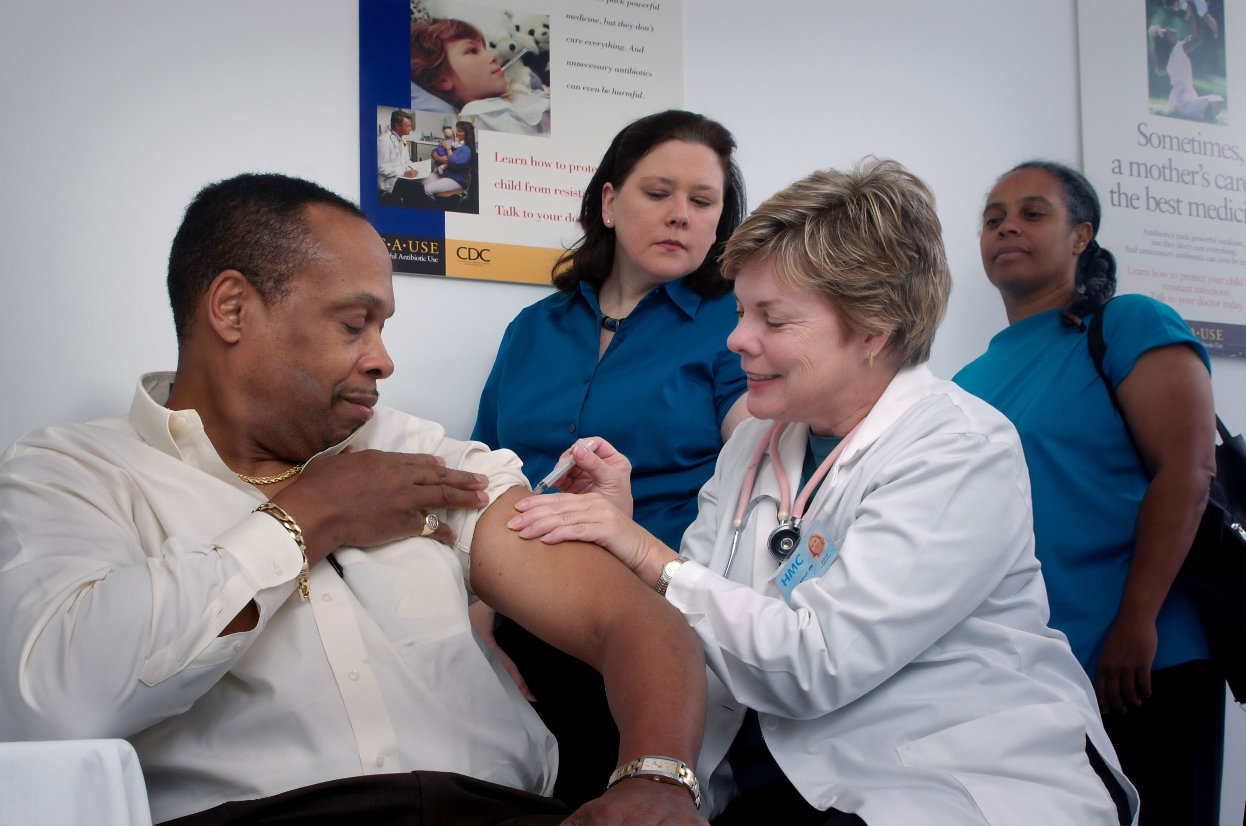 Health nurse giving vaccination to person