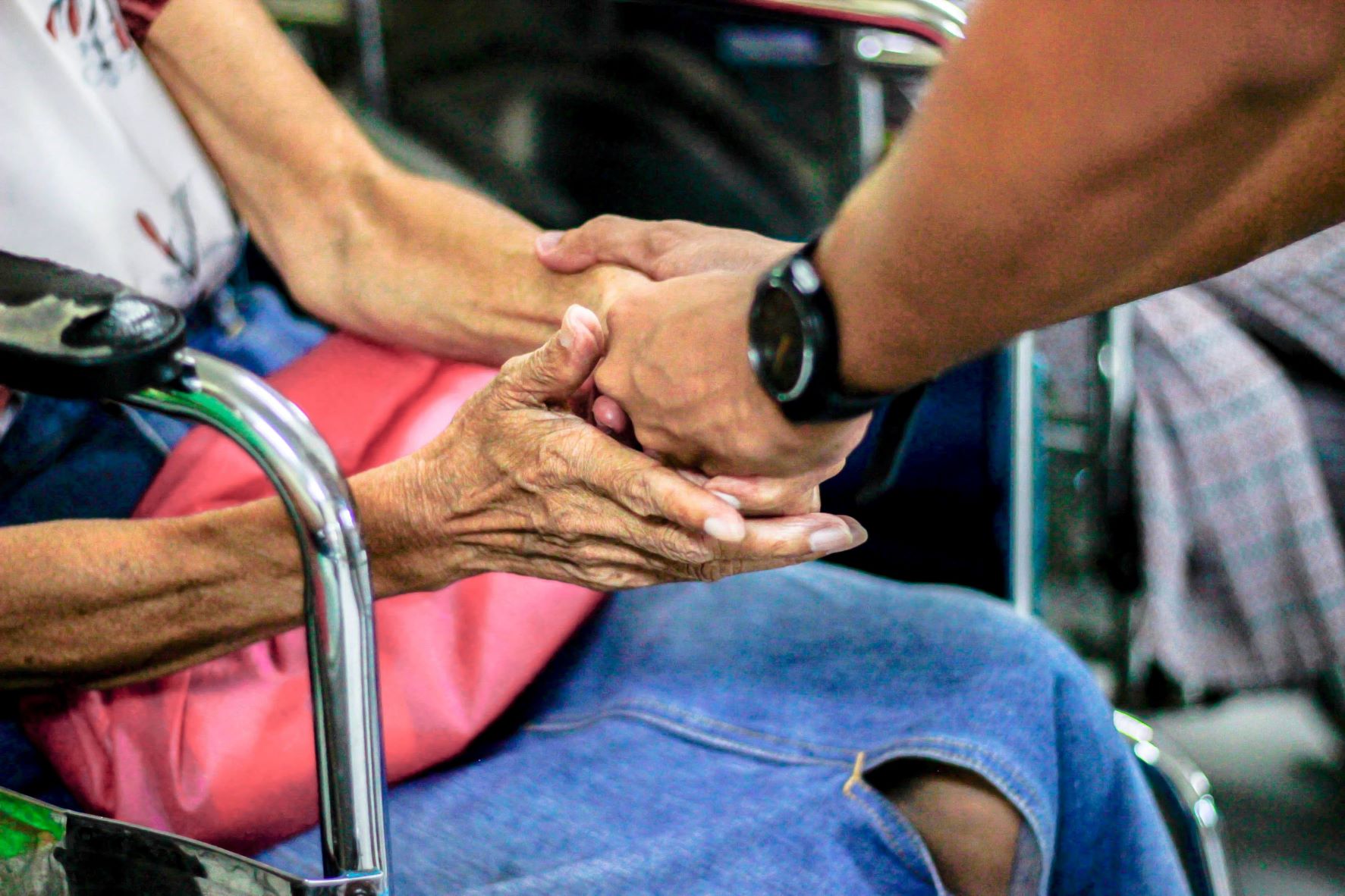 Person holding hands with elderly person