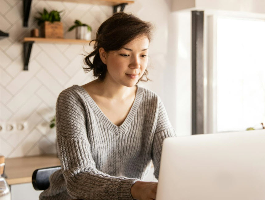 Person working at laptop in their home