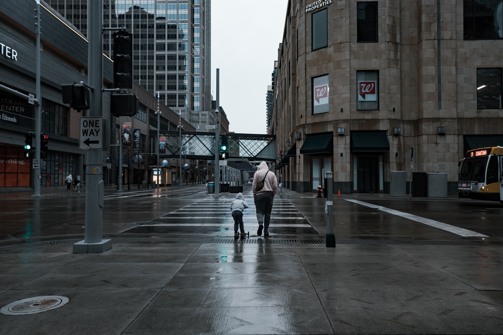 Two people in crosswalk on Minneapolis street