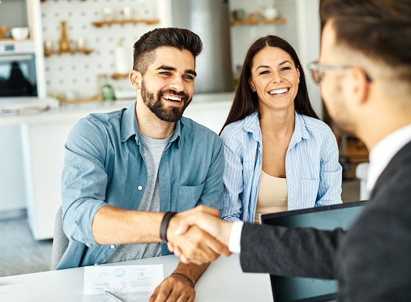 smiling people shaking hands