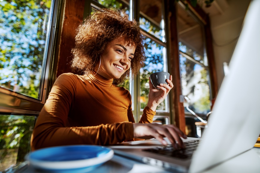 Person looking at laptop smiling Person looking at laptop smiling
