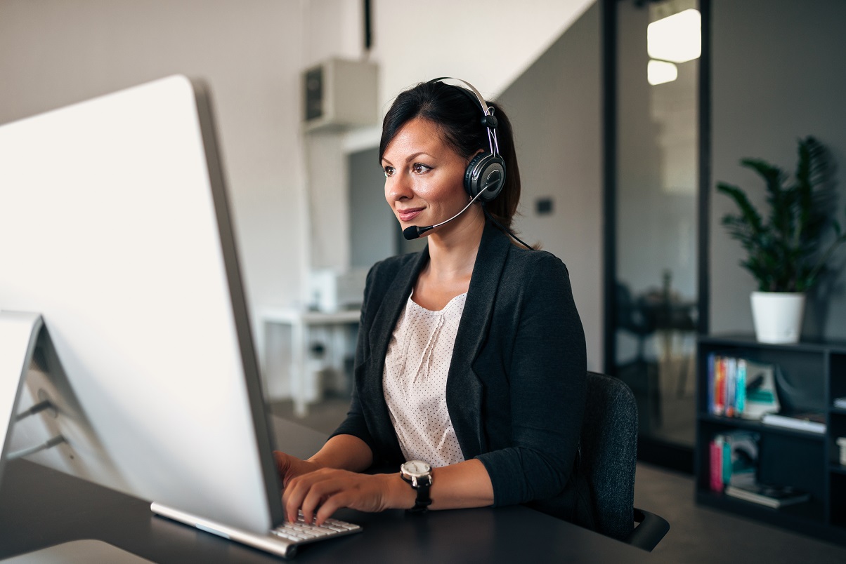 person with headset at computer