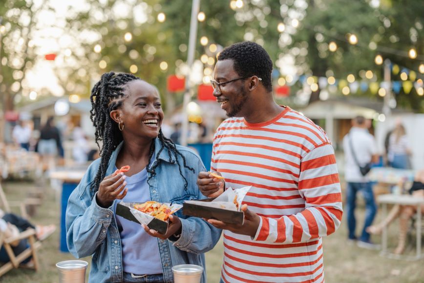 Smiling friends enjoying snacks at an event