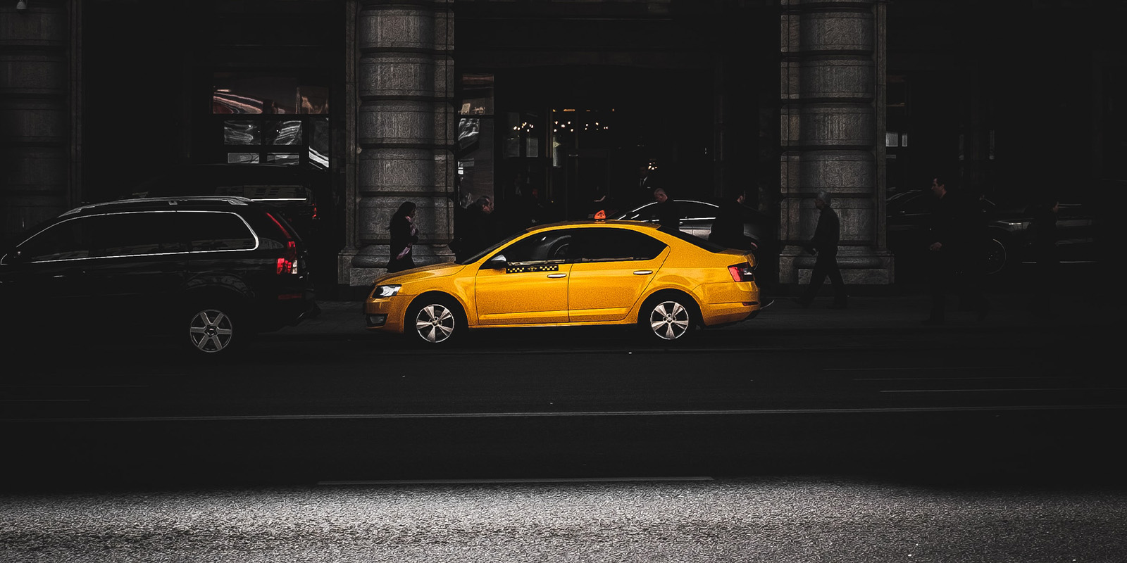 taxi cab on roadway at night