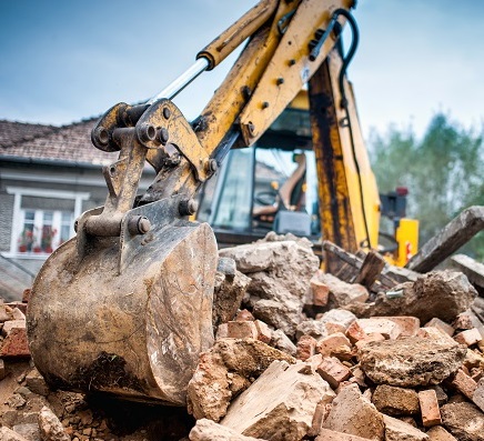 machine digging at demolition site