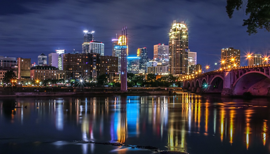 Minneapolis city lights reflecting on the river at night.