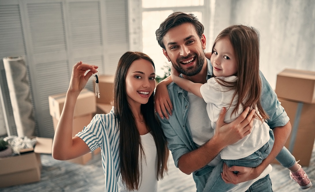 Smiling family with keys to new home