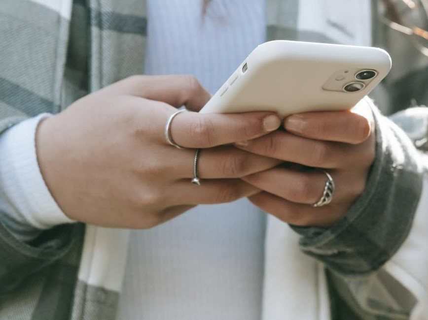 Hands typing on phone