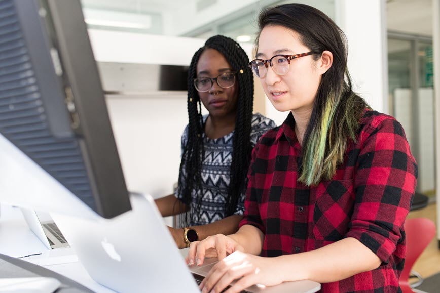 Two people working on computers