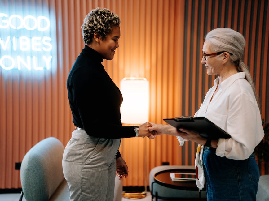 Two people shaking hands in job interview