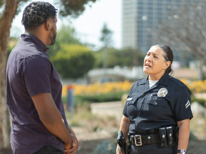 Police talking with a man outdoors