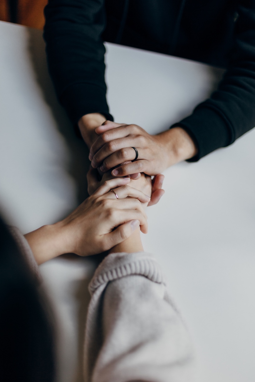 Hands of one person supporting another.