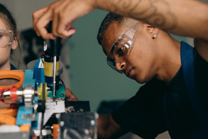 Person using screwdriver on computer hardware