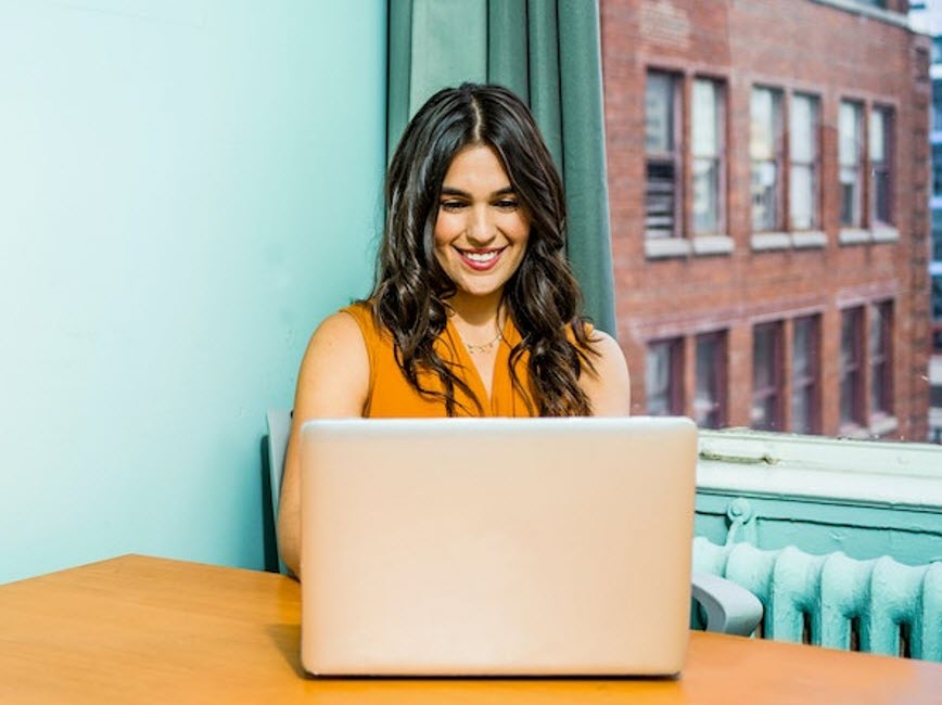 Woman on laptop smiling