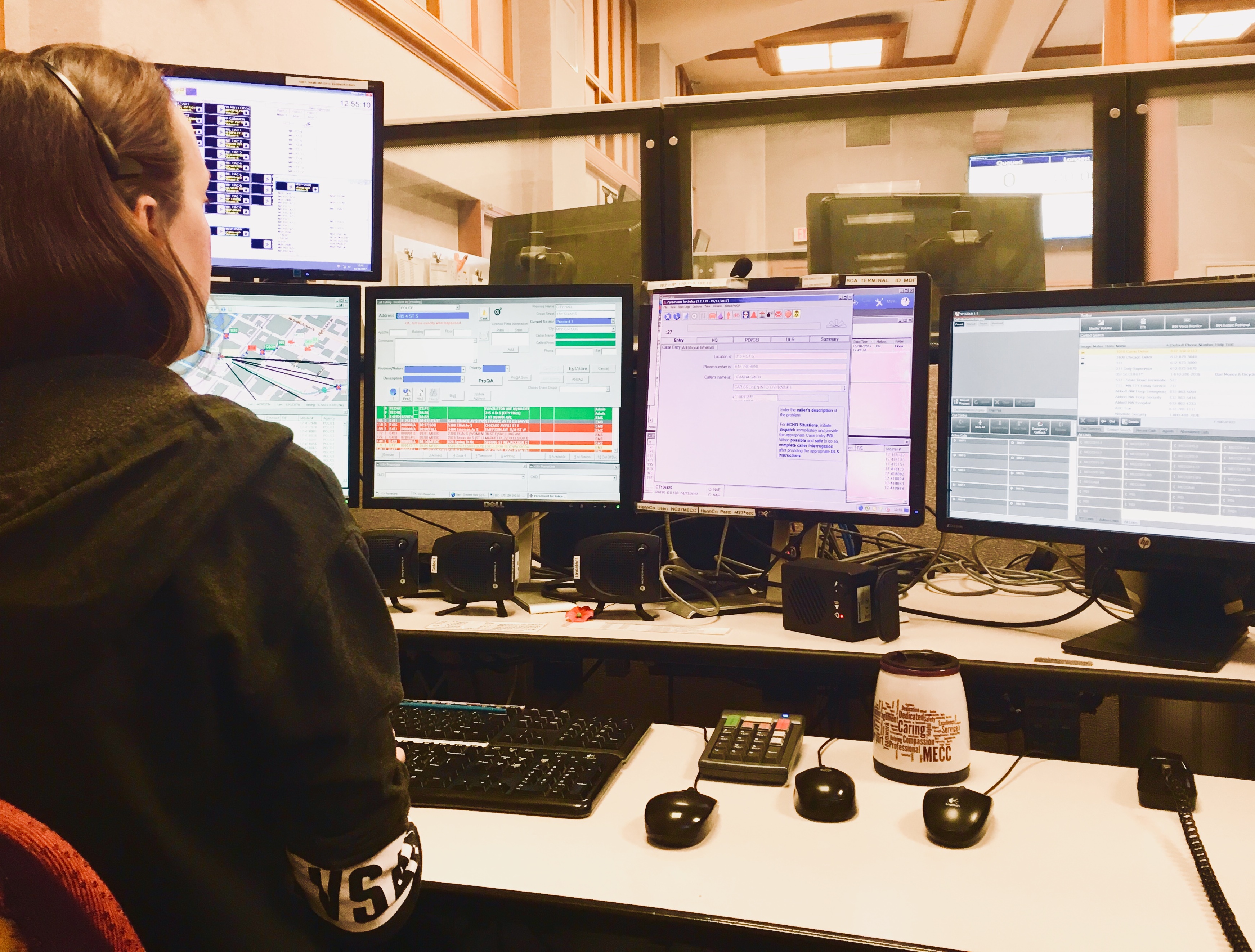 Person monitoring four computer screens 