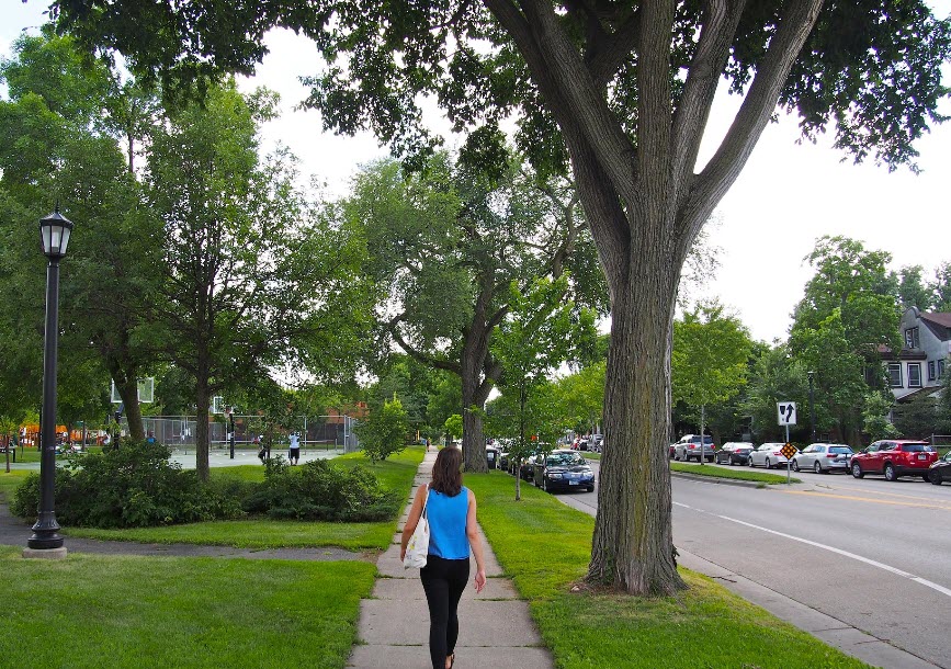 Woman walking down sidewalk